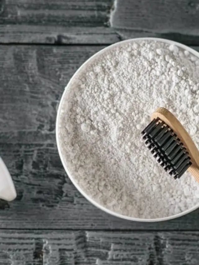 cropped-Canva-Tooth-powder-wooden-toothbrush-and-tooth-figurine-on-black-wooden-table.-The-view-from-the-top.-Flat-lay..jpg